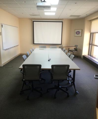 Conference Room with long table and 12 chairs around it.